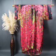 Pink and black kimono robe displayed on bamboo bar