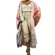 woman wearing a wildflower printed kimono robe over off white day wear