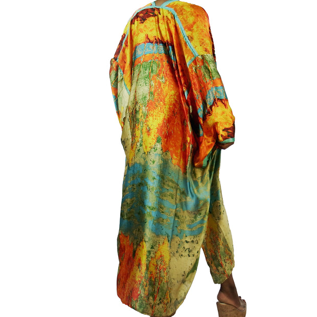 woman wearing a long kimono robe in orange gold and teal 