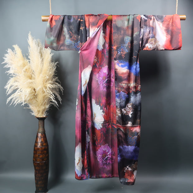 burgundy red and black kimono robe pictured hanging on bamboo bar displaying floral painted inner lining