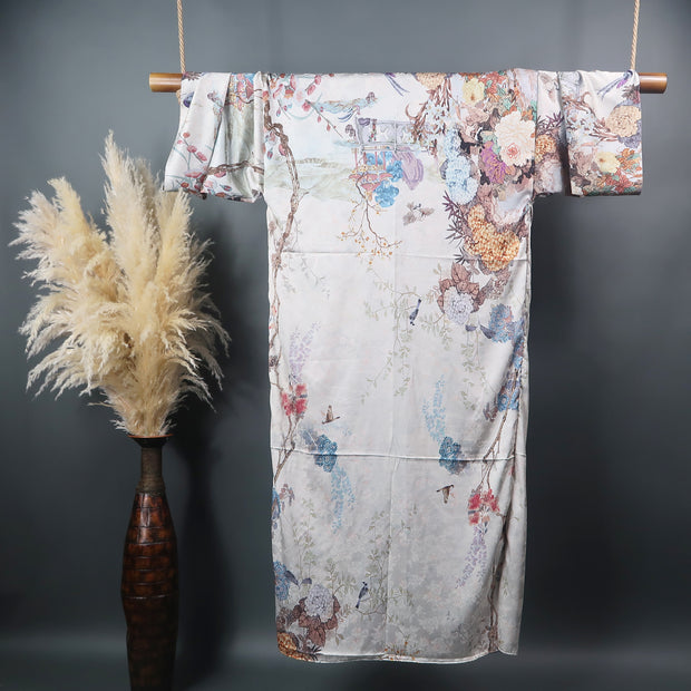 floor length kimono robe pictured from the back showing muted muted flower pattern on a taupe grey background