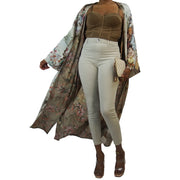 Nude flowered floor length kimono jacket blowing in the wind worn over nude outfit