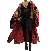 pink and black kimono worn over black evening wear blowing in breeze