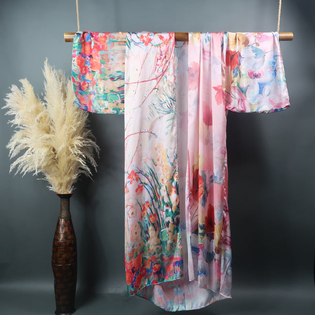 pink wildflower printed kimono robe hanging from a bamboo display rod